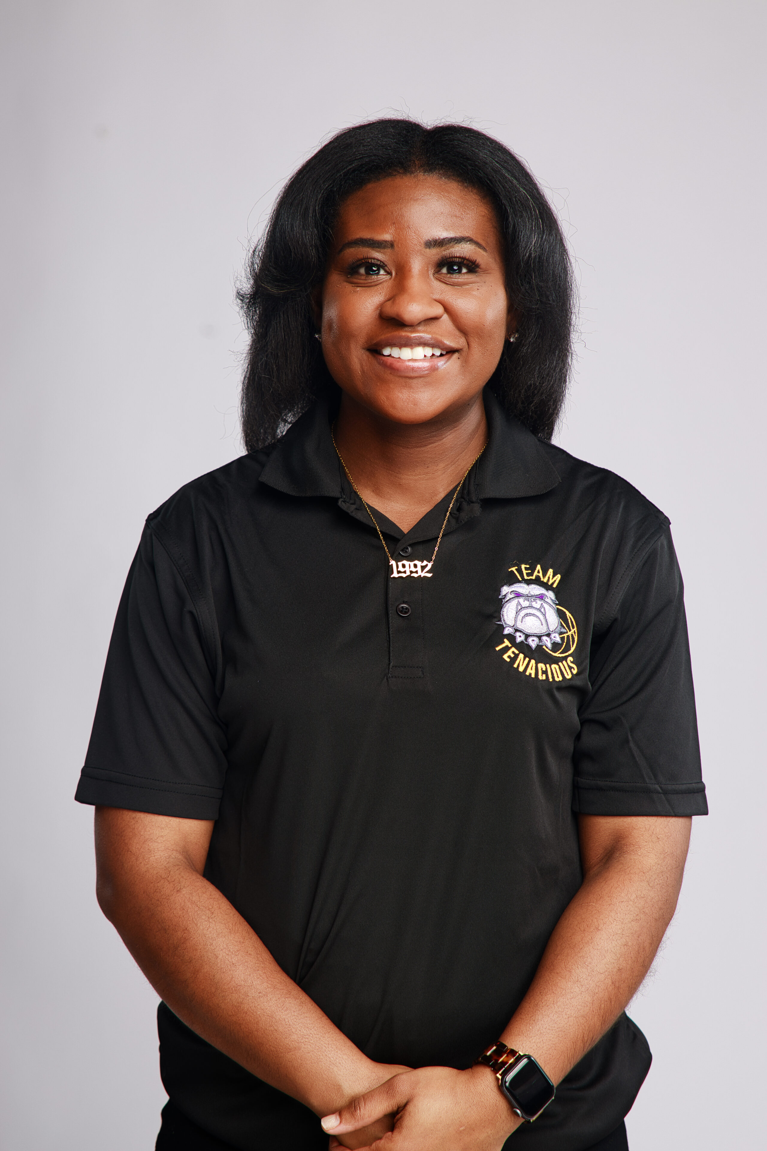 A woman in black shirt smiling for the camera.