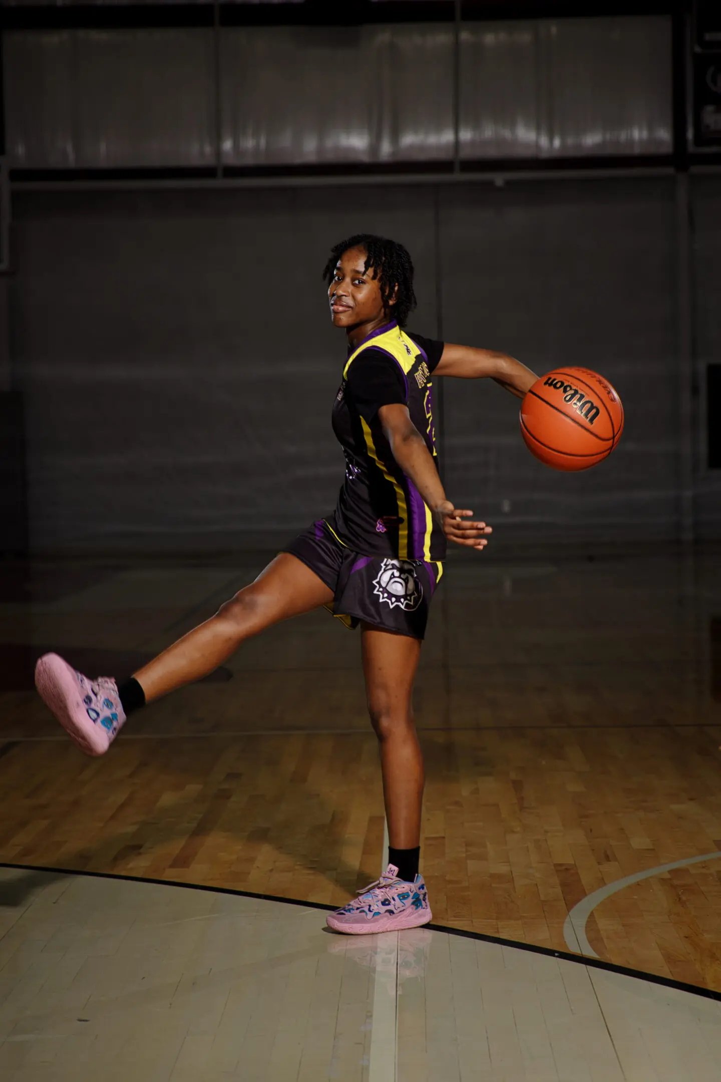 A girl is playing basketball on the court